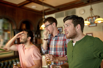 Image showing friends with beer watching sport at bar or pub