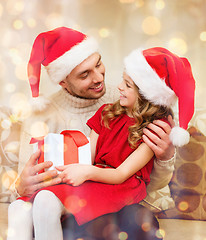 Image showing smiling father and daughter holding gift box