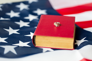 Image showing close up of american flag, wedding rings and bible