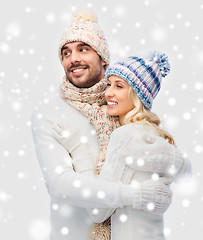 Image showing smiling couple in winter clothes hugging