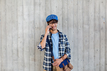 Image showing man with bag calling on smartphone at street wall