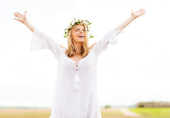 Image showing happy young woman in flower wreath on cereal field