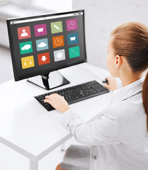 Image showing businesswoman with menu icons on office computer