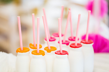 Image showing close up of bottles with drinks and straws