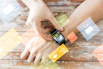 Image showing close up of male hands setting smart watch