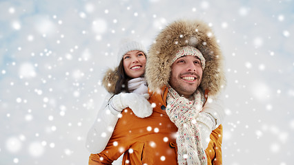 Image showing happy couple having fun over winter background