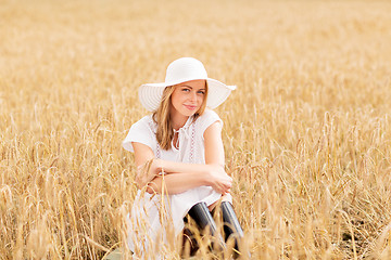 Image showing happy young woman in sun hat on cereal field