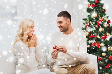 Image showing man giving woman engagement ring for christmas