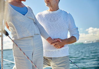 Image showing happy senior couple on sail boat or yacht in sea