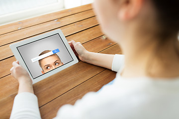 Image showing close up of woman with search bar on tablet pc