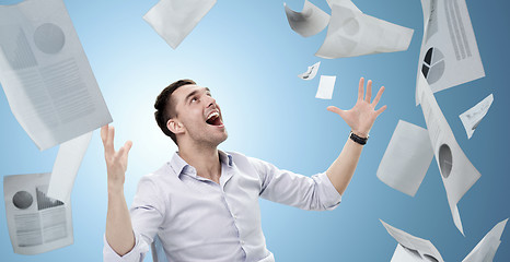 Image showing businessman with falling papers