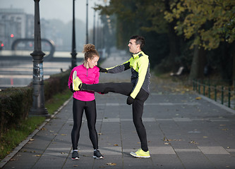 Image showing couple warming up before jogging