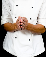 Image showing Professional chef with a hand gesture towards, wearing a chefs j