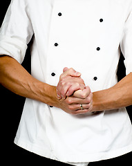 Image showing Professional chef with a hand gesture towards, wearing a chefs j