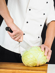 Image showing Professional chef holding a sharp cooking knife onto a whole cab