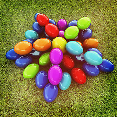 Image showing Colored Easter eggs as a flower on a green grass. 3D illustratio