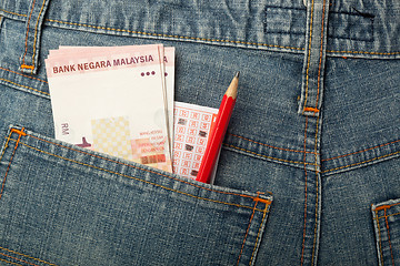 Image showing Malaysian money and lottery bet slip in pocket