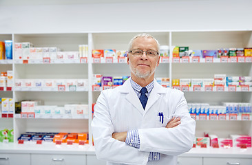 Image showing senior male pharmacist in white coat at drugstore