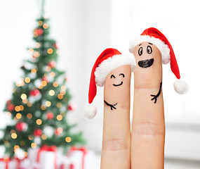 Image showing close up of two fingers with smiley and santa hats
