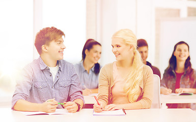 Image showing two teenagers with notebooks at school