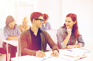 Image showing smiling students with notebooks at school