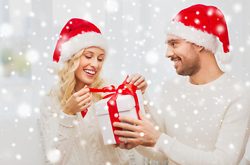 Image showing happy couple at home with christmas gift box