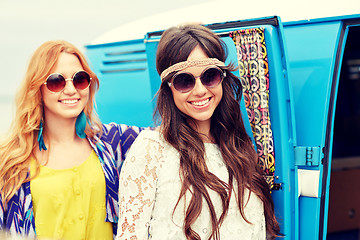 Image showing smiling young hippie women over minivan car