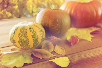 Image showing close up of pumpkins on wooden table outdoors