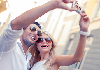 Image showing travelling couple taking photo picture with camera