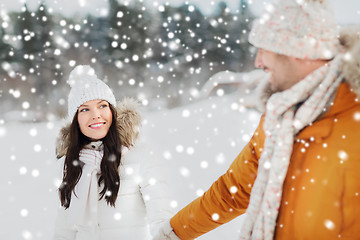 Image showing happy couple walking over winter background