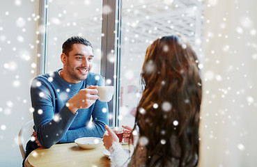 Image showing happy couple drinking tea and coffee at cafe