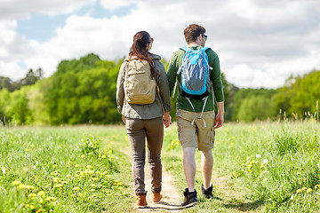 Image showing happy couple with backpacks hiking outdoors