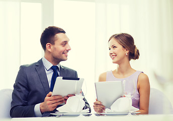 Image showing couple with menus on tablet pc at restaurant