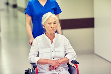 Image showing nurse with senior woman in wheelchair at hospital
