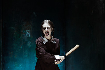 Image showing Portrait of a young girl in school uniform as killer woman