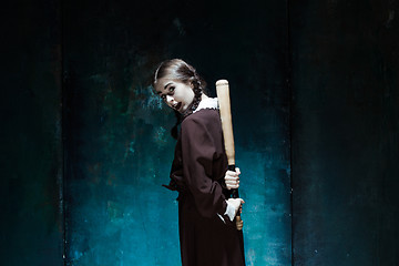 Image showing Portrait of a young girl in school uniform as killer woman