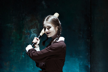 Image showing Portrait of a young girl in school uniform as killer woman