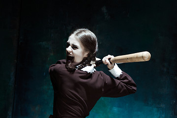 Image showing Portrait of a young girl in school uniform as killer woman