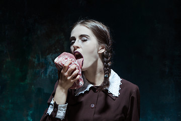 Image showing Bloody Halloween theme: crazy girl with raw meat