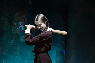 Image showing Portrait of a young girl in school uniform as killer woman