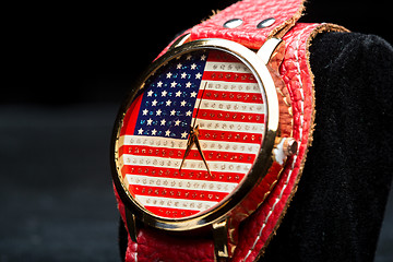 Image showing clock on a black background. American Flag