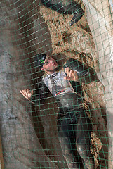 Image showing Man creeps on an entrenchment with sand and water