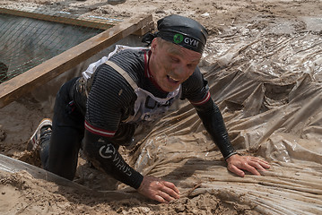 Image showing Man creeps on an entrenchment with sand and water