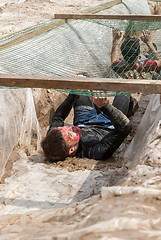 Image showing Men creep on an entrenchment with sand and water