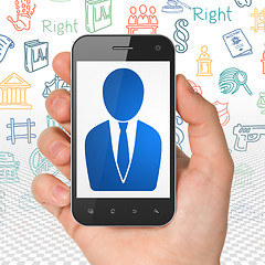 Image showing Law concept: Hand Holding Smartphone with Business Man on display