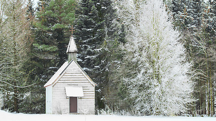 Image showing Winter view little snow-capped rural wooden church in frozen for