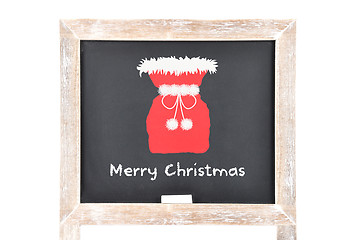 Image showing Christmas greetings with Santas bag on blackboard