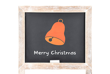 Image showing Christmas greetings with bell on blackboard
