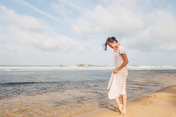 Image showing Woman walking on the beach