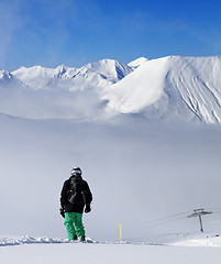 Image showing Snowboarder on snowy slope with new fallen snow